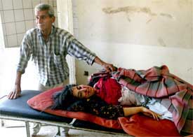 April 4th , Najem Khalaf weeps next to his daughter, Nadia, 33, killed by a U.S. missile