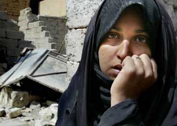 An Iraqi woman sitting in front of her house destroyed during U.S. strike  on  Baghdad, April 2nd