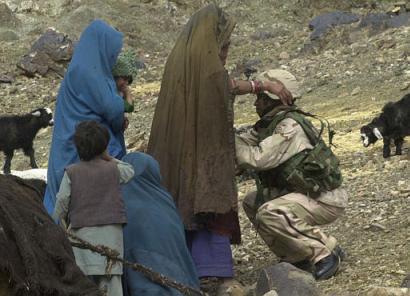 A U.S. soldier frisks Afghan women in a village in the central part of the Baghran river valley. [AP photo/Aaron Favila]