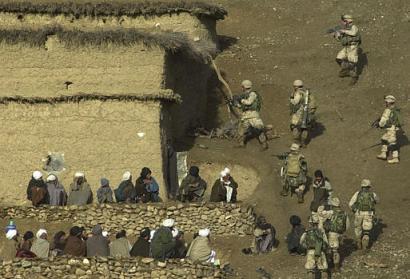 Soldiers of the 82nd Airborne search a house in a village of the Baghran valley on February 24, 2003 [AP photo/Aaron Favila]